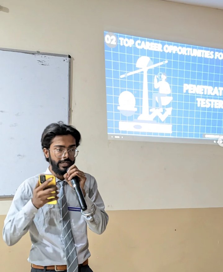 Pranjul Rathour in a shirt and tie holding a microphone in front of a career-opportunities slide
