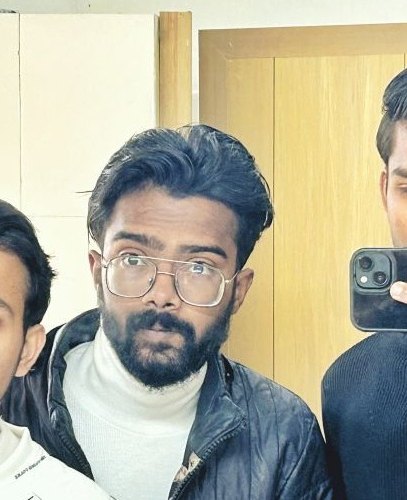 Pranjul Rathour in a suit and tie with a lanyard at a formal campus event