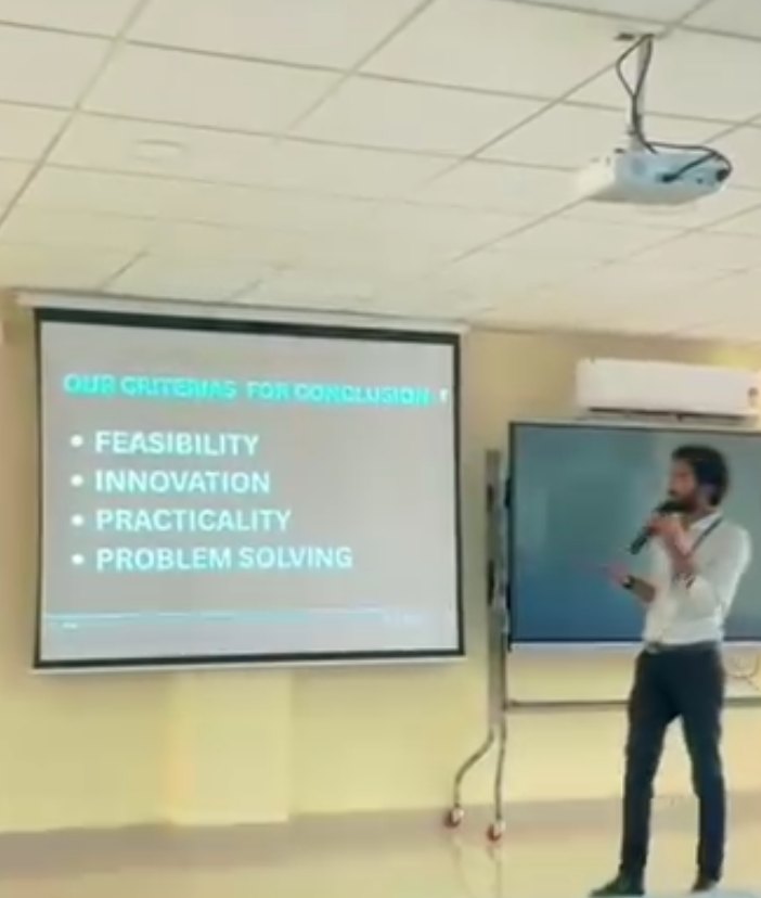 Pranjul Rathour presenting evaluation criteria — feasibility, innovation, practicality, problem solving — on a projector screen