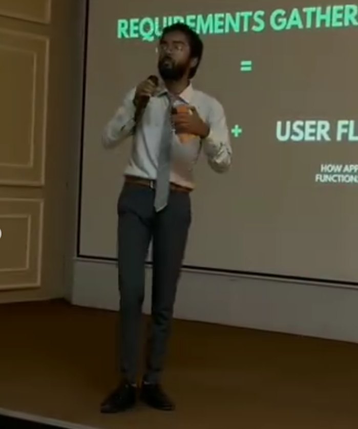 Pranjul Rathour on stage presenting a requirements-gathering and user-flow slide